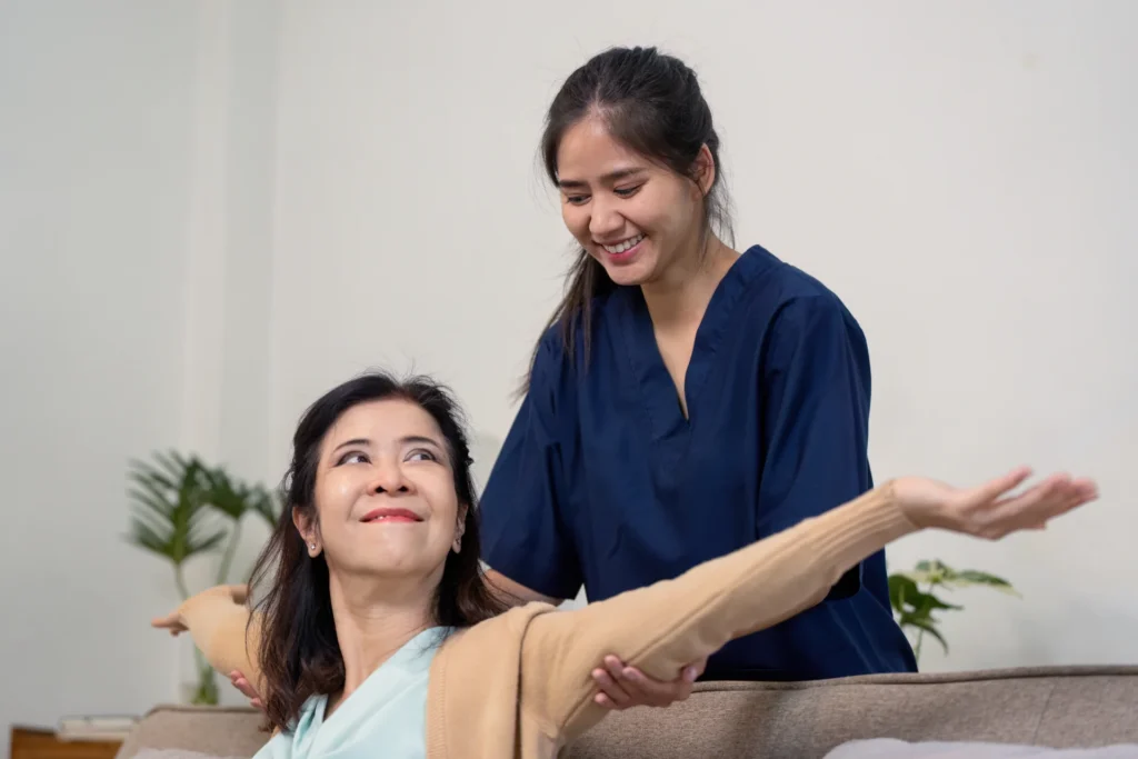 woman receives assistance with arm exercises indoo 2026 03 25 04 48 39 utc